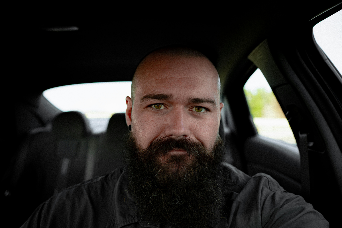 Dad sitting in his car parenting after separation
